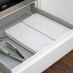 Space saving dish drying mat stored flat inside a kitchen drawer